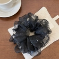 Detail of black double-layered mesh scrunchie with silver sequins on canvas background - Black