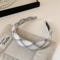 Detail eines karierten Stirnbands mit handgefertigtem Etikett auf beigem Stoff - Schwarz Weiß Streifen 3cm