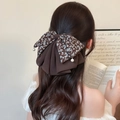 Elegant floral chiffon bow hair clip with pearl pendants in a French style ponytail look - Brown