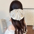 Elegante fermaglio per capelli a doppio fiocco con fiori e perle indossato da modella - Bianco Sporco