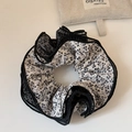 Macro detail of oversized floral fabric scrunchie with layered black mesh lace edging - Off-White Mesh Floral