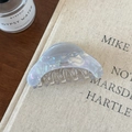 Détail de la pince à cheveux marbrée lavande avec texte Barrette La France sur livre - Bleu-Violet Irisé