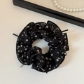 Detail of floral chiffon scrunchie with delicate pearl necklace on an elegant background - Black Floral