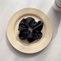 Elegant black satin hair scrunchie placed on a beige ceramic plate for retro hair styling - Black