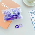 Detail of purple high-elastic hair bands in PVC packaging with fashion jewelry label - Purple Series