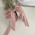 Detail of pink grosgrain ribbon bow hair clip showing textured edges and layers - Pink