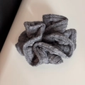Makro-Detail eines dunkelgrauen Strick-Haargummis mit Rippstruktur und weichem Stoff - Haargummi / Grau