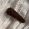 Detail of a dark brown plush oval hair clip on a natural white linen fabric surface - Plush Triangle Clip / Dark Brown
