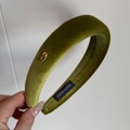 Detail of olive green velvet headband featuring a handmade gold metal tag and thick padding - Yellow-Green