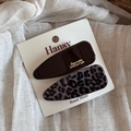 Detail view of leopard print and black hair clips with gold lettering on display card - Large Water Drop Style