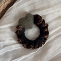 Detail of leopard print and black fabric scrunchie with a green plush heart charm - Green Heart