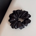 Detail shot of black satin scrunchie with sparkling rhinestones and elegant fabric folds - Regular Style / Black