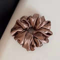 Detailed view of glossy bronze satin scrunchie with sparkling rhinestone embellishments - Regular Style / Brown