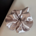 Detail shot of champagne satin scrunchie with sparkling rhinestones and silky texture - Oversized Style / Beige Apricot