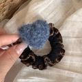 Detail of leopard print hair scrunchie with a blue plush heart charm in hand - Blue Heart