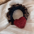 Detail of leopard print scrunchie featuring a red plush heart and retro lace textures - Red Heart