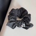 Detail of dark grey hair scrunchie with silver rhinestones and a textured fabric bow - Bow Style