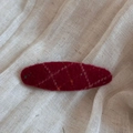 Detail of red wool felt hair clip with elegant hand-embroidered plaid on beige fabric - Spotted Plaid Oval BB-Red