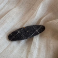 Close-up of dark grey wool felt hair clip with quilted stitching and colorful accents - Spotted Plaid Oval BB-Gray