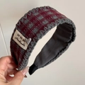 Close-up of retro plaid scrunchie with handmade label and heart lucky charm - Gray Red Plaid Fabric Headband