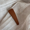 Close-up of brown floral fabric BB hair clip on a textured beige linen background - Yellow Solid Triangle Clip