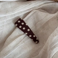 Detailed macro of vintage floral knit BB hair clip with brown fabric and white flowers - Brown Floral Triangle Clip