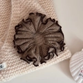 Close-up of dark brown scrunchie with hemmed edges on soft knit background - Brown