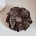 Detailed view of dark brown polka dot scrunchie with soft pleated fabric and wavy edges - Pleated Polka Dot / Coffee