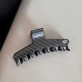 Detail of silver-grey carbon fiber pattern hair claw clip with silver Hand Made plaque - Thick Bar Clip