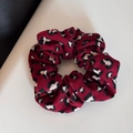 Detail of red hairband with leopard pattern texture on leather and white surface - Scrunchie / Red Leopard