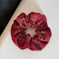Detailed close-up of red plaid flannel fabric scrunchie with soft winter texture - Scrunchie / Light Plaid