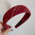 Macro detail of red plaid hairband featuring a handmade woven label and thick fabric - Padded Headband / Light Plaid