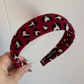 Detailed close-up of red and black leopard print thick knit headband with handmade label - Padded Headband / Red Leopard