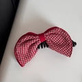 Detailed view of red and white plaid fabric bow hair claw clip with black plastic teeth - New Year Red Plaid Bow Vertical Clip