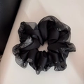 Detailed close-up of a black satin scrunchie featuring rhinestone edges and organza trim - Black (Sparkling Rhinestone Black Mesh)