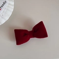 Detailed top view of dark red velvet bow hair clip with French vintage aesthetic - Red