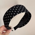Detail of a wide black fabric headband with white polka dots and non-slip inner lining - Black Polka Dot Headband