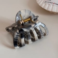 Detail view of smoky grey ink wash marble hair claw clip with golden metal spring - Pumpkin Shape Claw