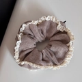 Detailed close-up of brown knitted scrunchie featuring vintage cream lace trim borders - Pink