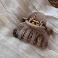 Close-up of khaki ink marble hair claw clip with gold metal spring on linen - Pumpkin Style (Khaki Ink)