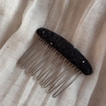 Detail of a handmade black polka dot wool felt hair comb with ten silver metal teeth - Black Polka Dot (Oval Hair Comb)