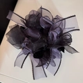 Detail of multi-layered tulle bow scrunchie with delicate wavy edges and bicolor design - Purple