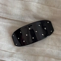 Detailed view of elegant black resin barrette featuring sparkling rhinestones on fabric - Black Polka Dot