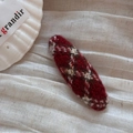 Detail of red plaid knit hair clip with fuzzy texture on a white decorative background - Red Oval Clip-White Plaid