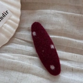 Close-up of deep red wool felt hair clip with white polka dots on soft fabric - Red Oval Clip-Snowflake Dots