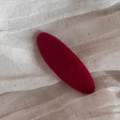 Close-up of deep red oval flocking BB hair clip on a natural cotton fabric background - Red Oval Clip-Solid Red