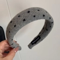 Detail of grey wool headband with black polka dots featuring a sewn Hand Made label - Woolen Grey Dot Headband
