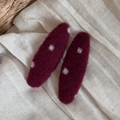 Close-up of wool polka dot hair clips in deep red on natural linen background - Woolen Red Dot Oval Hairpin Pair
