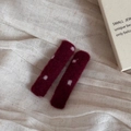 Close-up of red wool felt hair clips with white polka dots on a textured beige fabric - Woolen Red Dot Rectangle Hairpin Pair