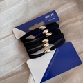 Detail of five high-elastic black hair ties with gold beads on the original card - Basic Gold Clasp Flat Black Group